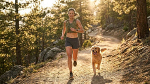 Woman running on a trail with her dog