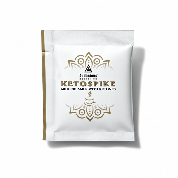 A single white stand-up pouch of Audacious Nutrition Ketospike Milk Creamer with Ketones, featuring gold and black text and decorative mandala-style graphics, set against a plain white background with a soft drop shadow.